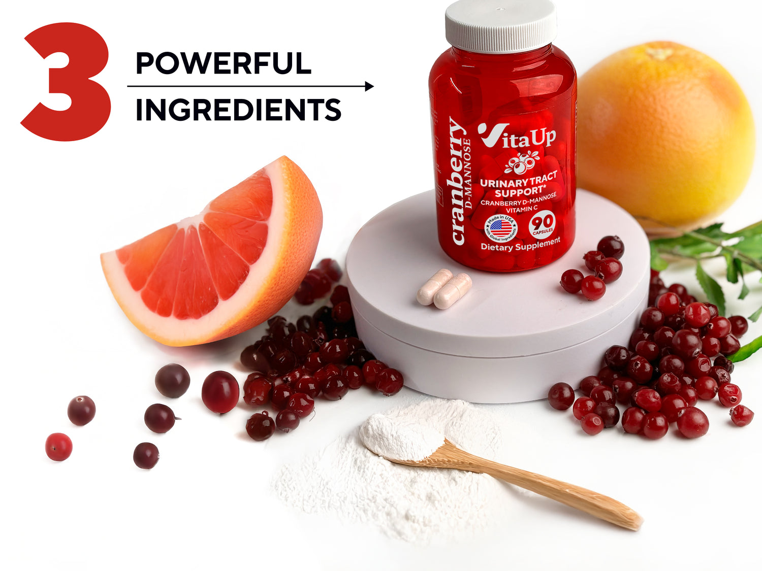 Supplement bottle with capsules, fresh cranberries, a grapefruit slice, and white powder on a wooden spoon to represent ingredients. A person holding the bottle is partially visible in the background.