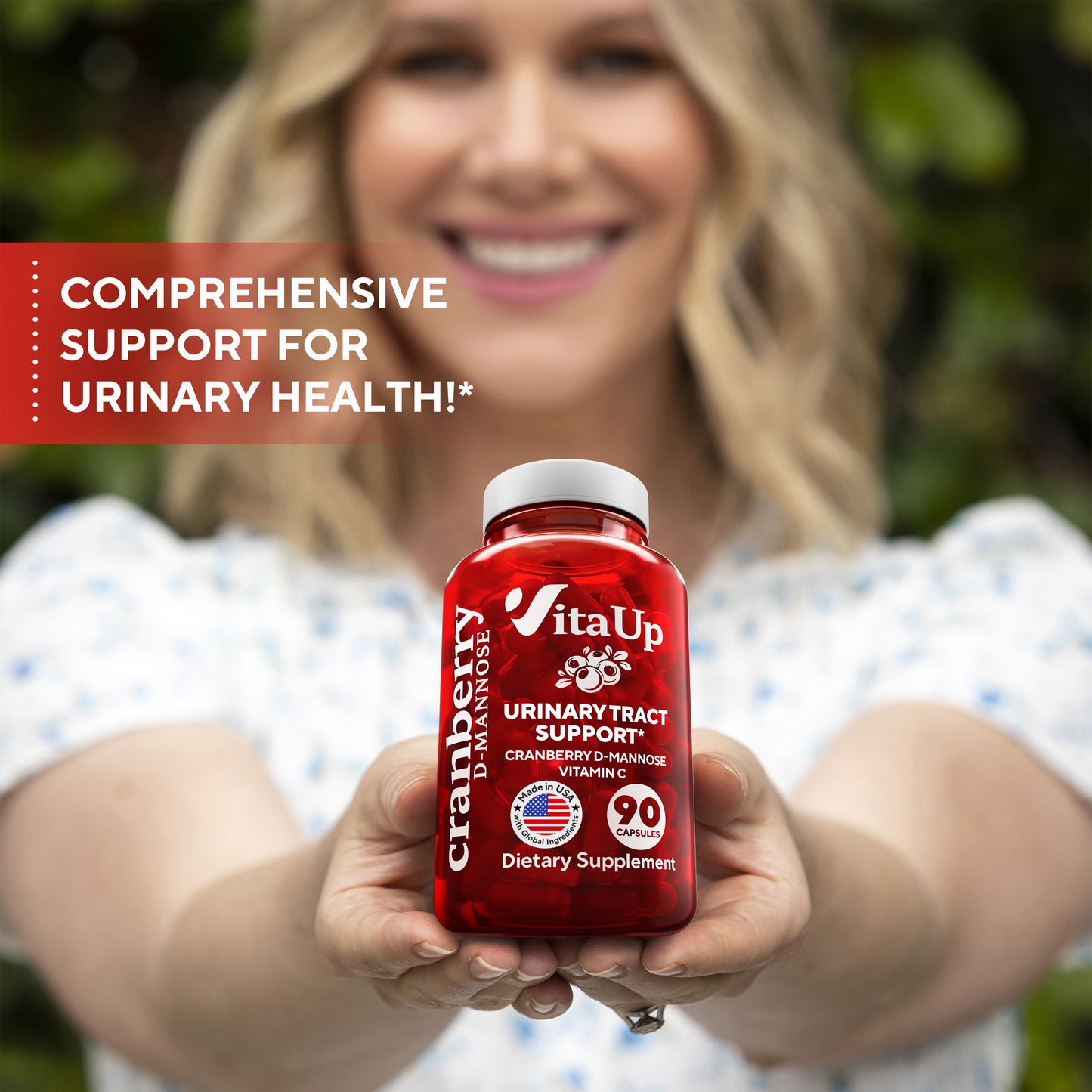 Woman holding a red supplement bottle labeled 'VitaUp' with text about urinary health support.