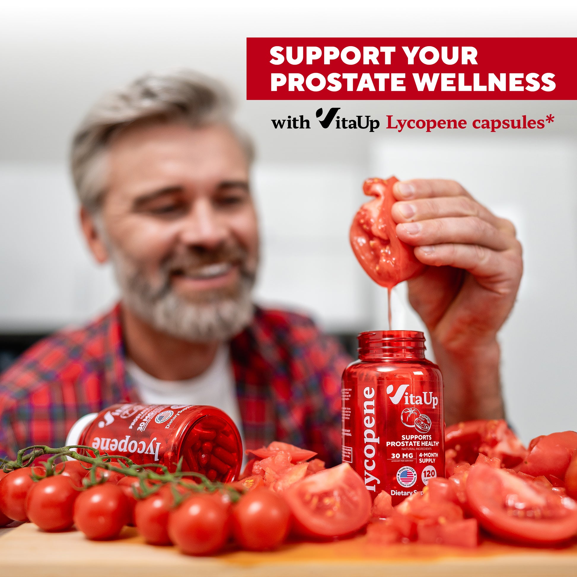 Smiling older man in a red flannel shirt squeezing a tomato into a VitaUp Lycopene bottle, surrounded by fresh tomatoes.