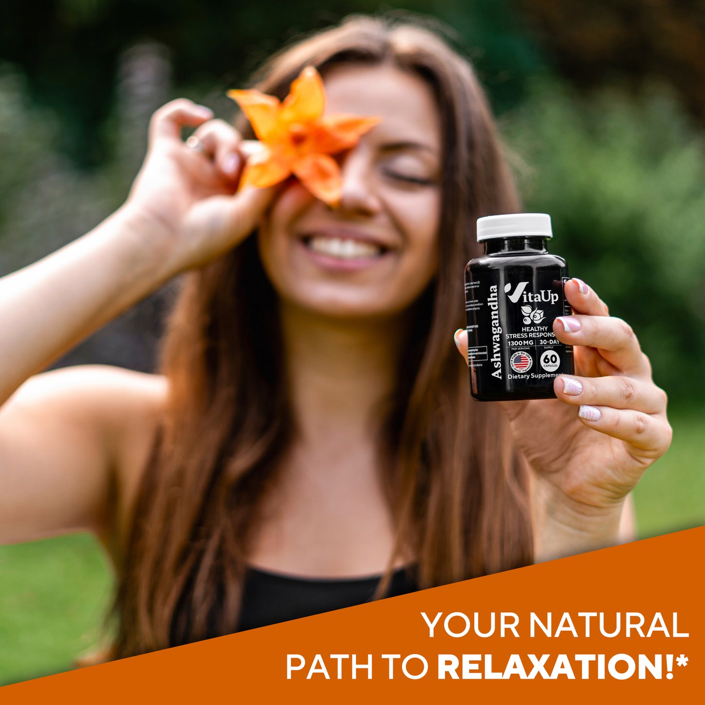 Woman holding VitaUp Ashwagandha bottle and orange flower, smiling and promoting natural relaxation