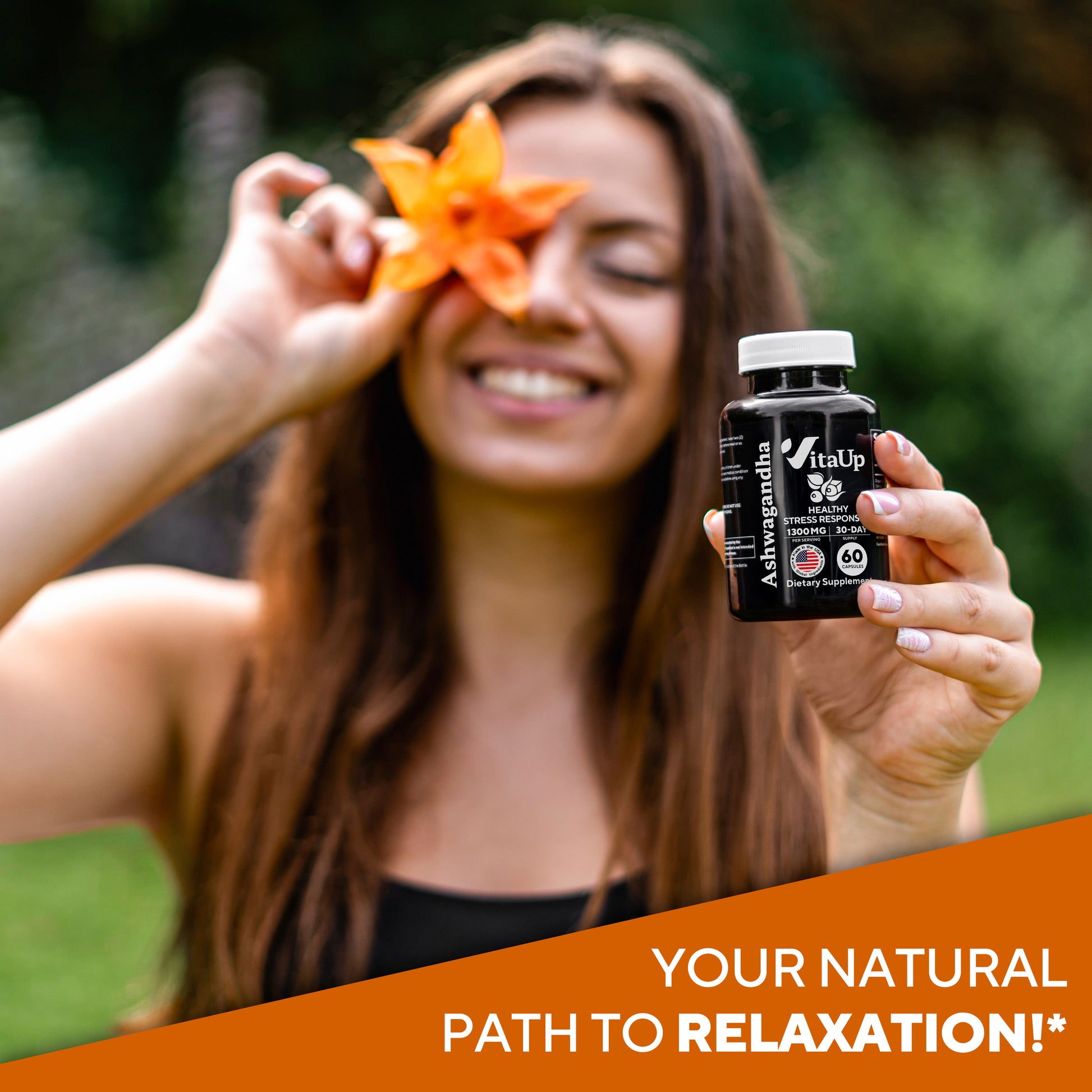 Woman holding VitaUp Ashwagandha bottle and orange flower, smiling and promoting natural relaxation