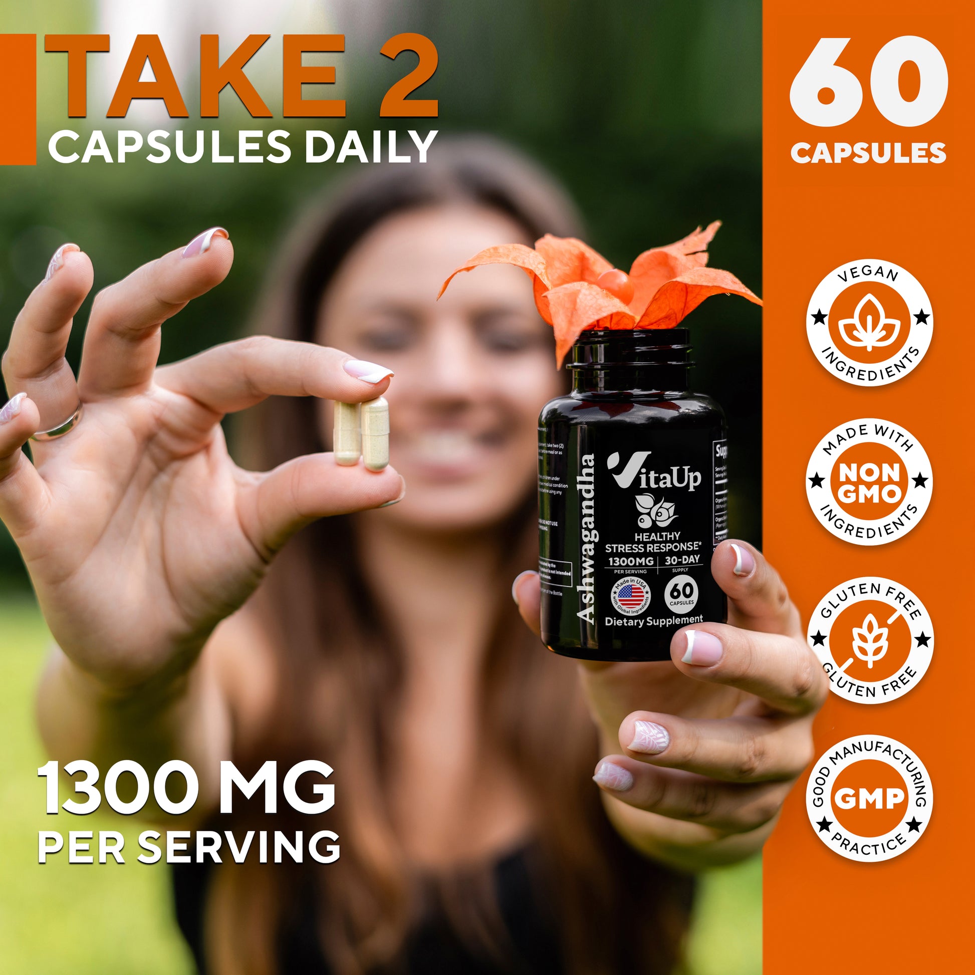 Woman smiling outdoors holding VitaUp Ashwagandha supplement and showing daily dose of two capsules.