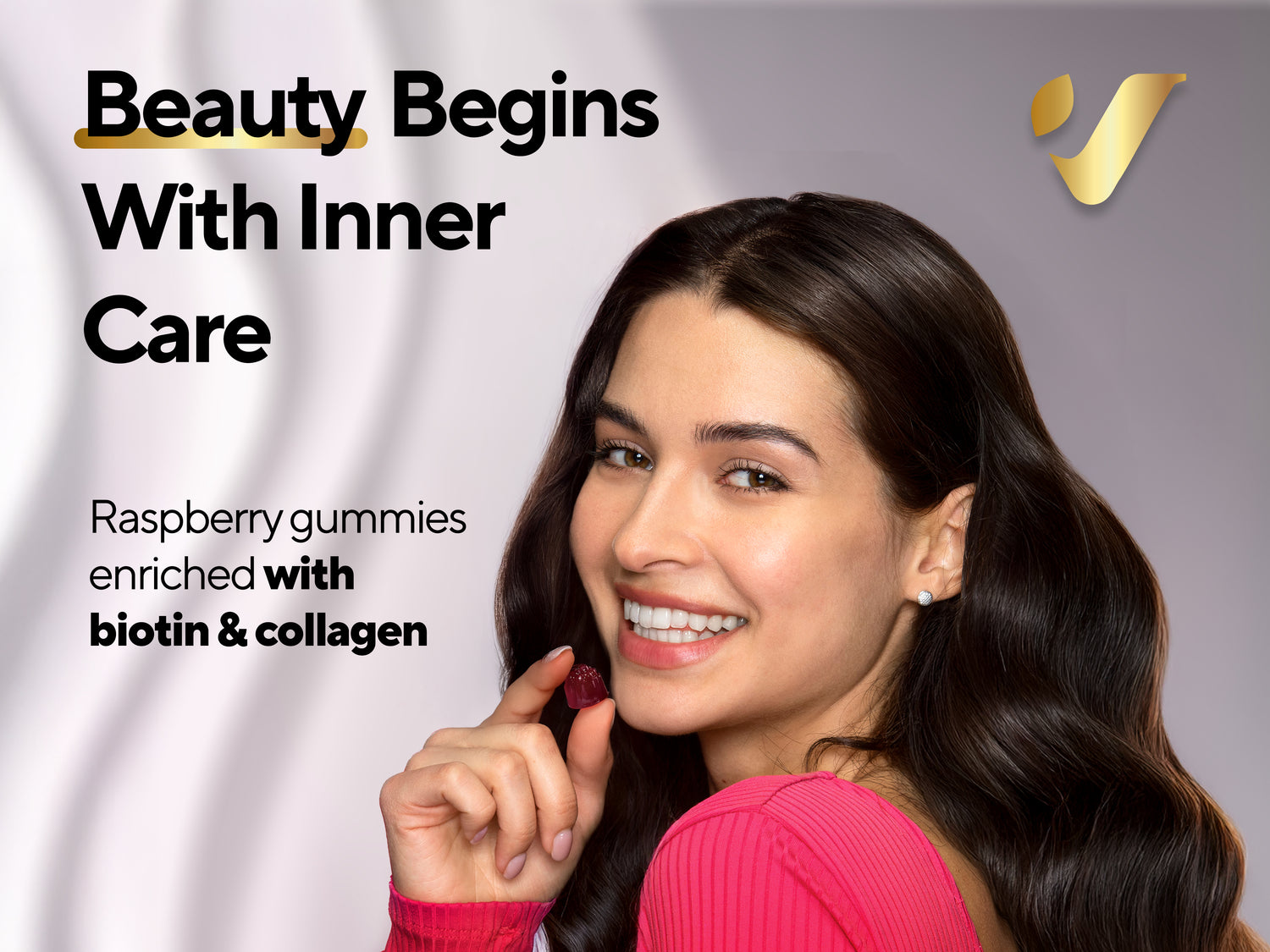 Smiling woman holding raspberry gummy, text: Beauty Begins With Inner Care, biotin & collagen