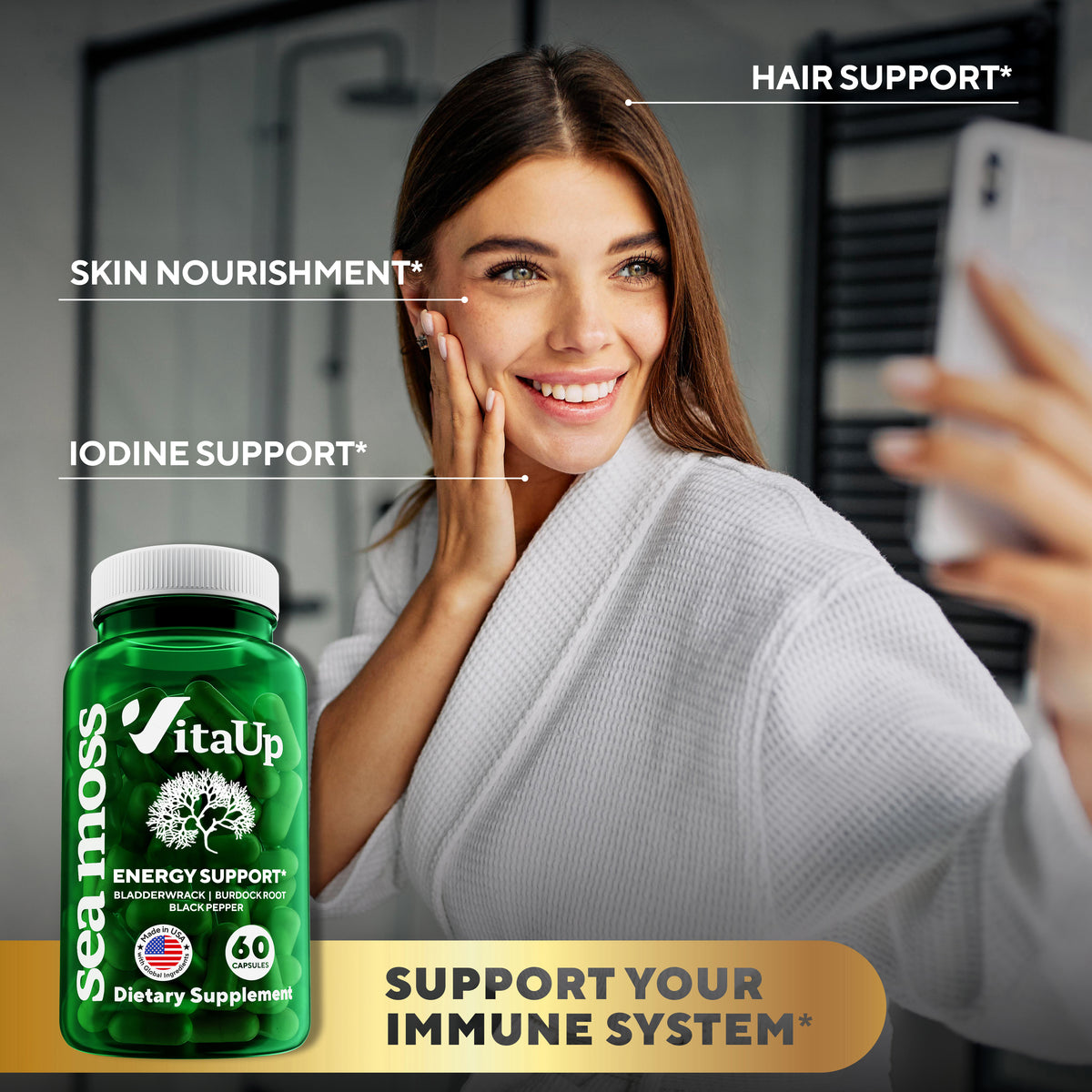 Woman holding VitaUp Sea Moss capsules and smiling outdoors with the bottle in hand.